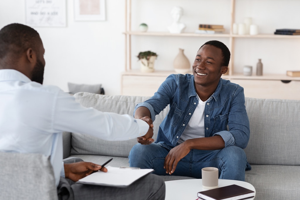 A case management behavioral health therapy session with two men